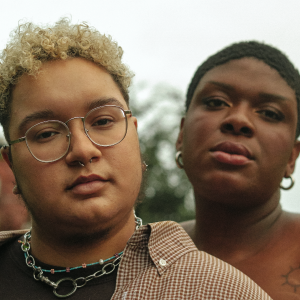 A transmasculine non-binary person and a binary trans woman standing next to each other